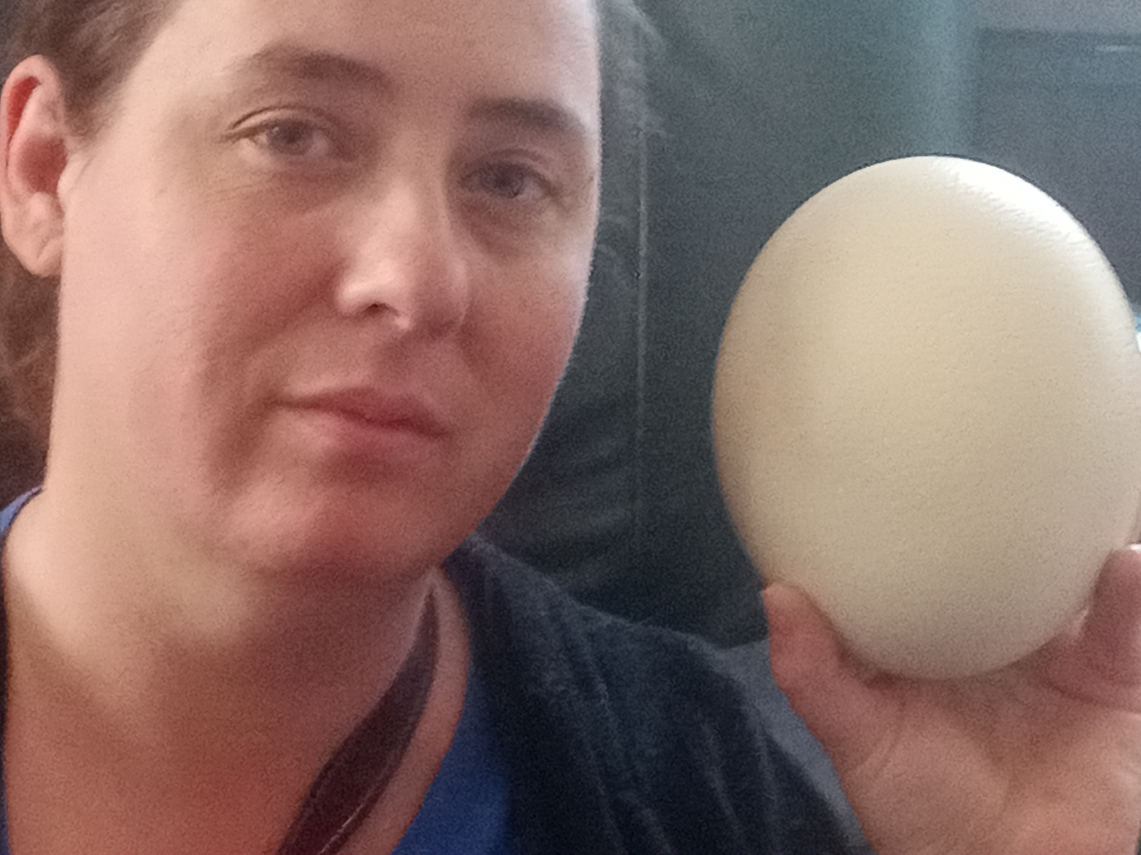 Caley Moore holding an Ostrich egg.